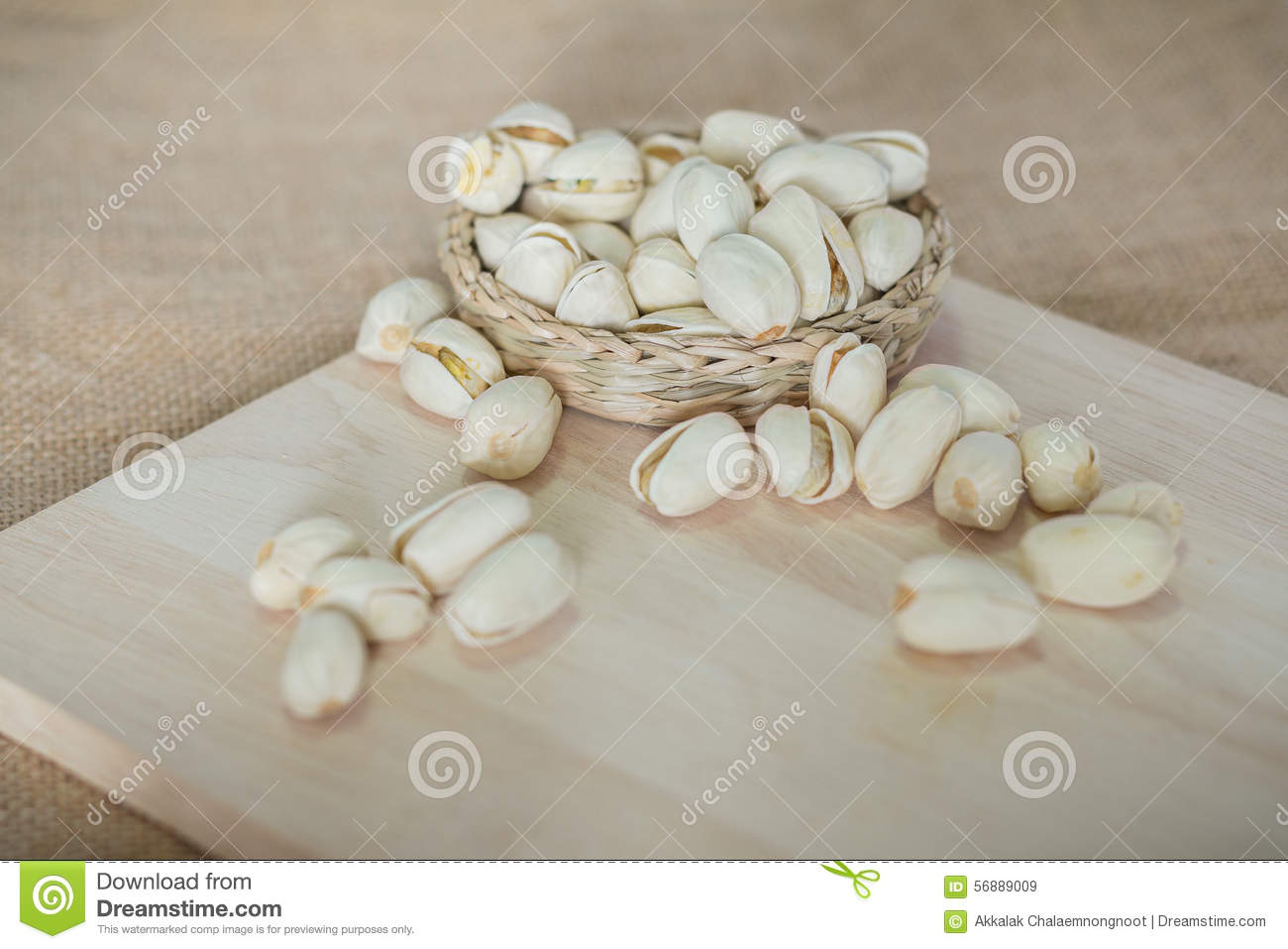 Salty Pistachios Nuts On Rustic Wooden Block 