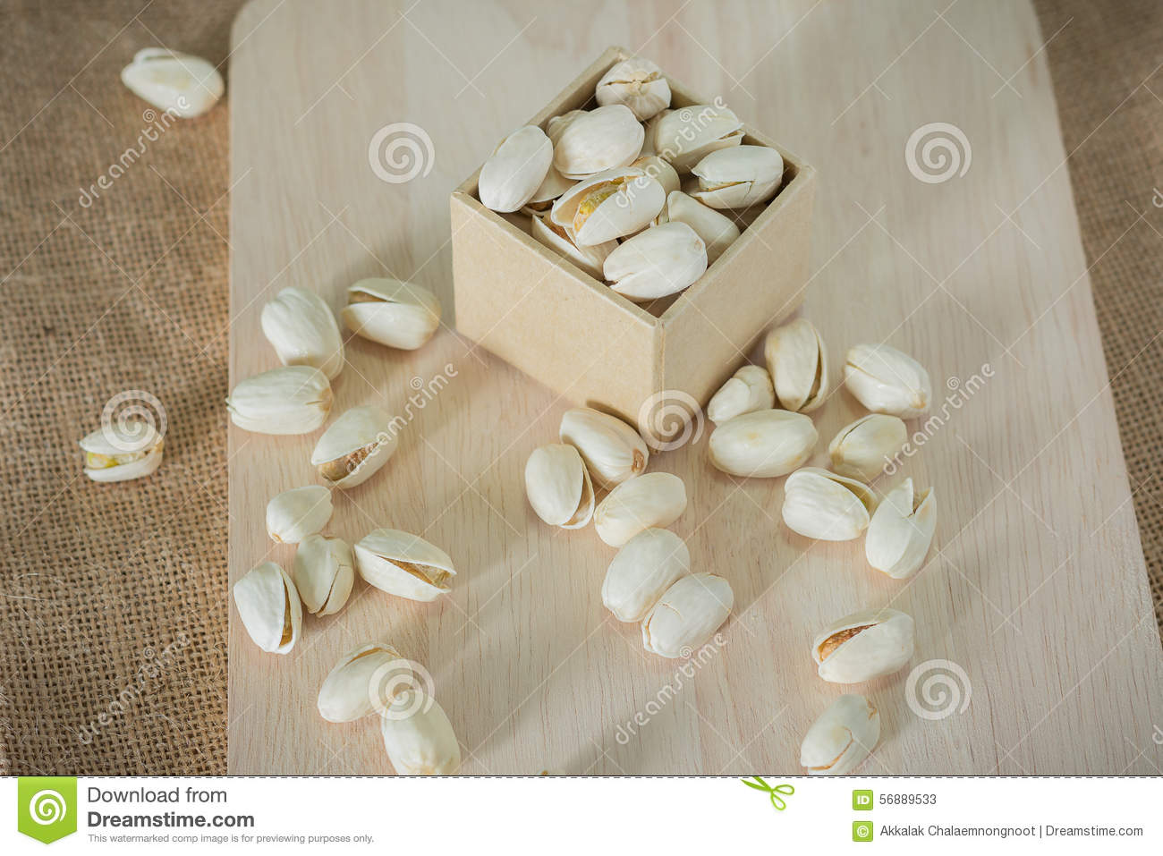 Salty Pistachios Nuts On Rustic Wooden Block