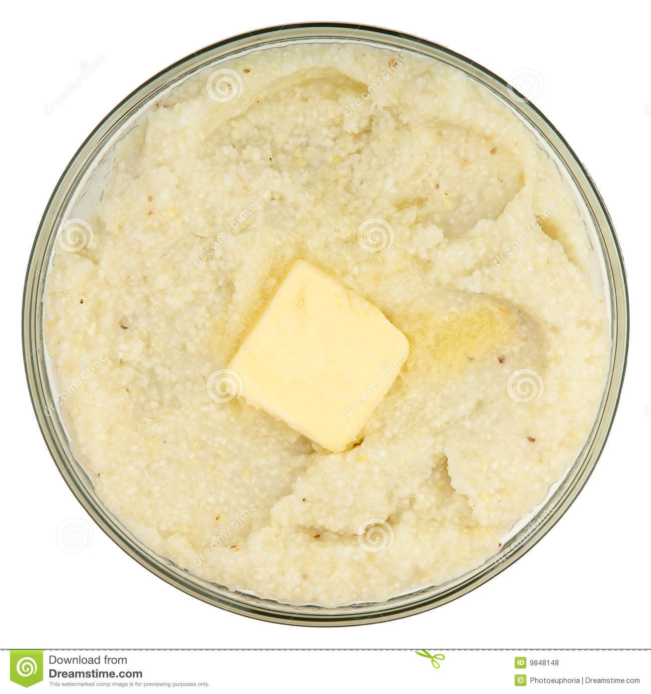 Close Up Bowl Of Grits With Butter In Glass Bowl Over White