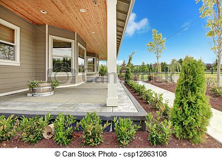Large Farm Country House With Long Covered Porch And Green Landscape 