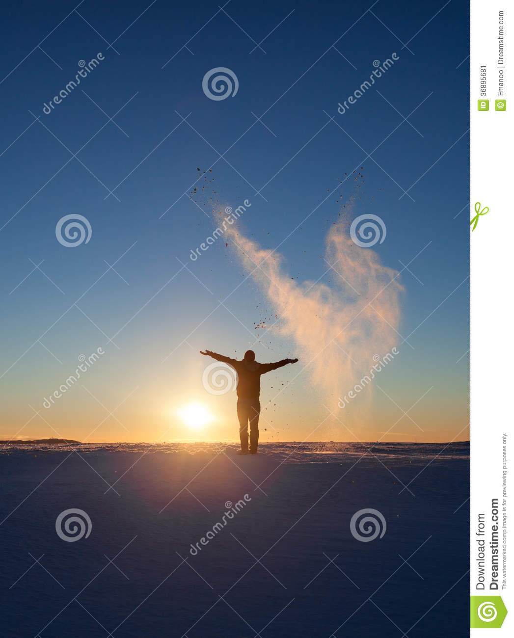 Silhouetted Man Standing In Winter Landscape And Throwing Snow Stock