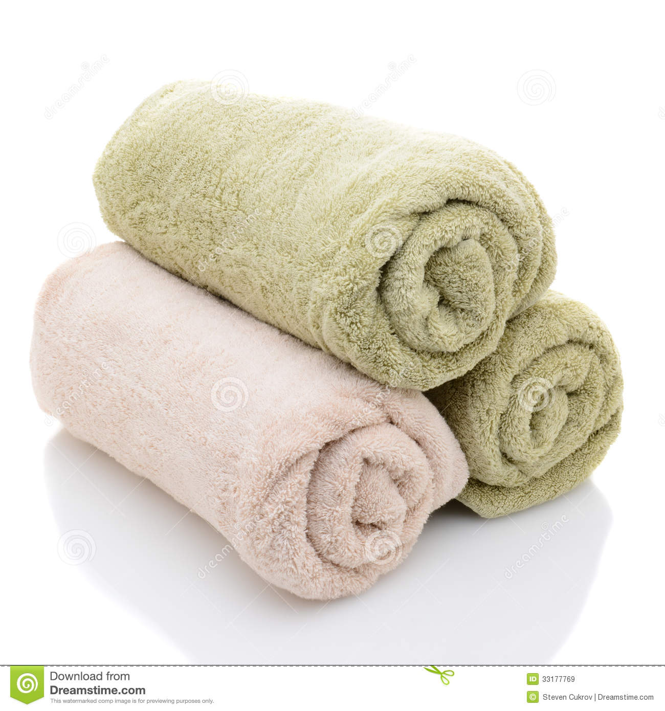 Three Rolled Bath Towels Freshly Laundered On A White Background With    