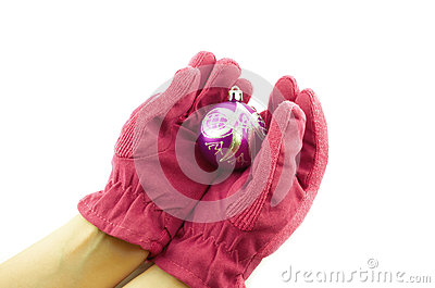Female Hands In Pink Gloves Holding A Christmas Ball 