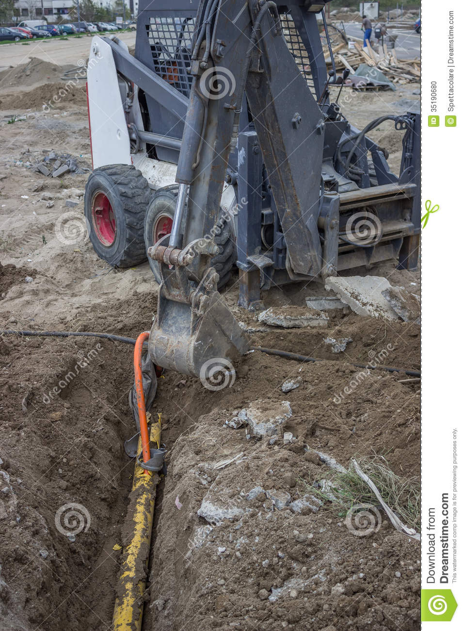 Mini Excavator Digging Up A Electrical Cables From Trench Stock Photo