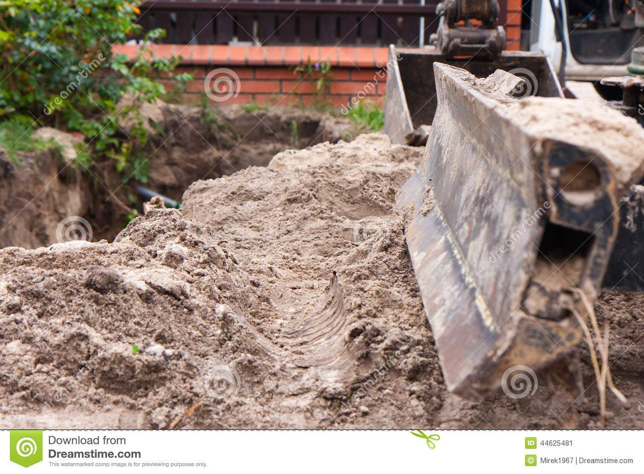 Small Excavator While Digging A Trench On A Construction Site 