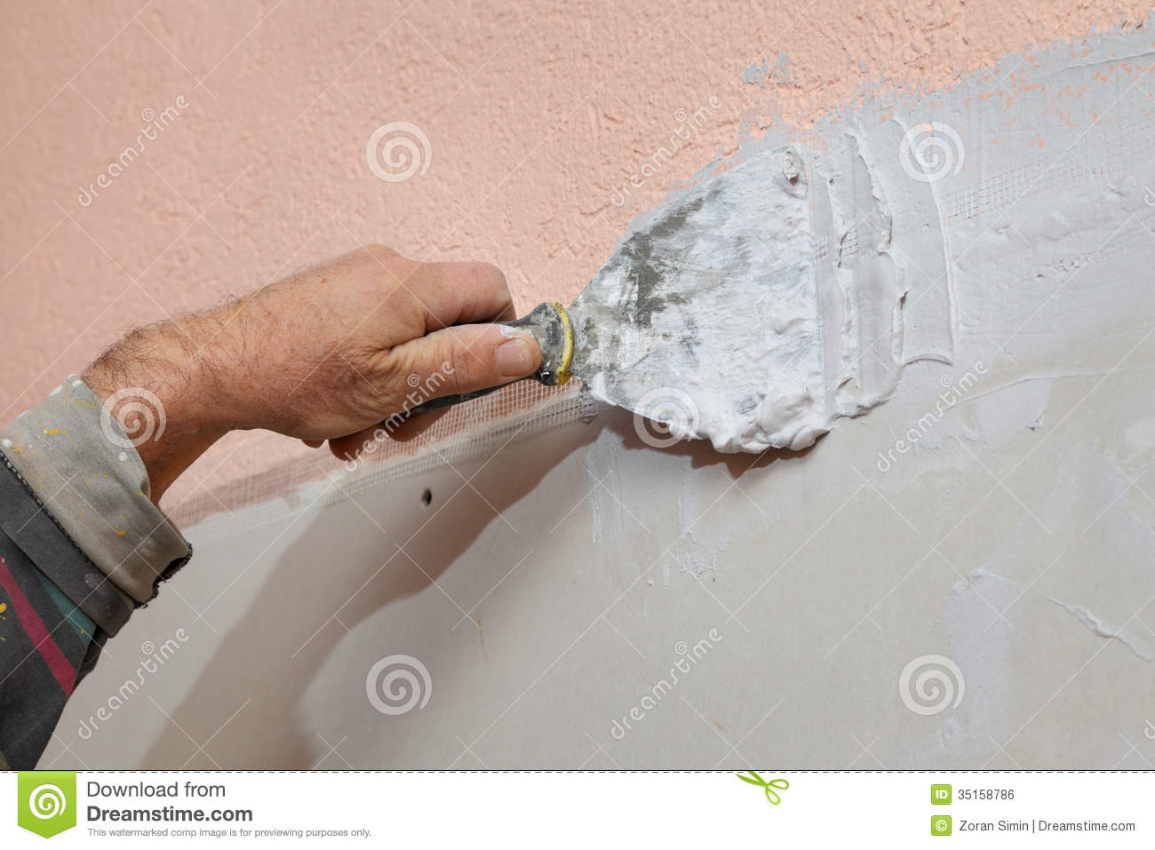 Worker Spreading Plaster With Trowel To Gypsum Board And Fiber Mesh