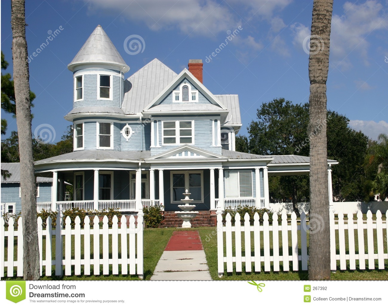 Blue Victorian Home With White Trim Andbordered By Picket Fence
