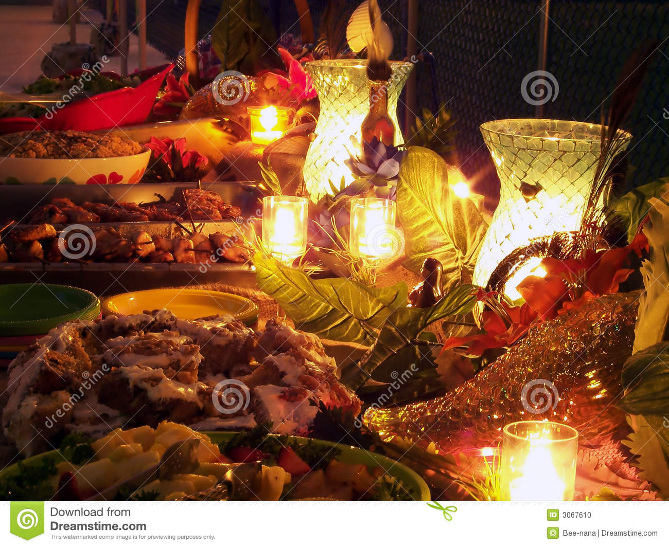 Candlelit Tropical Buffet Table Filled With Delicious Food