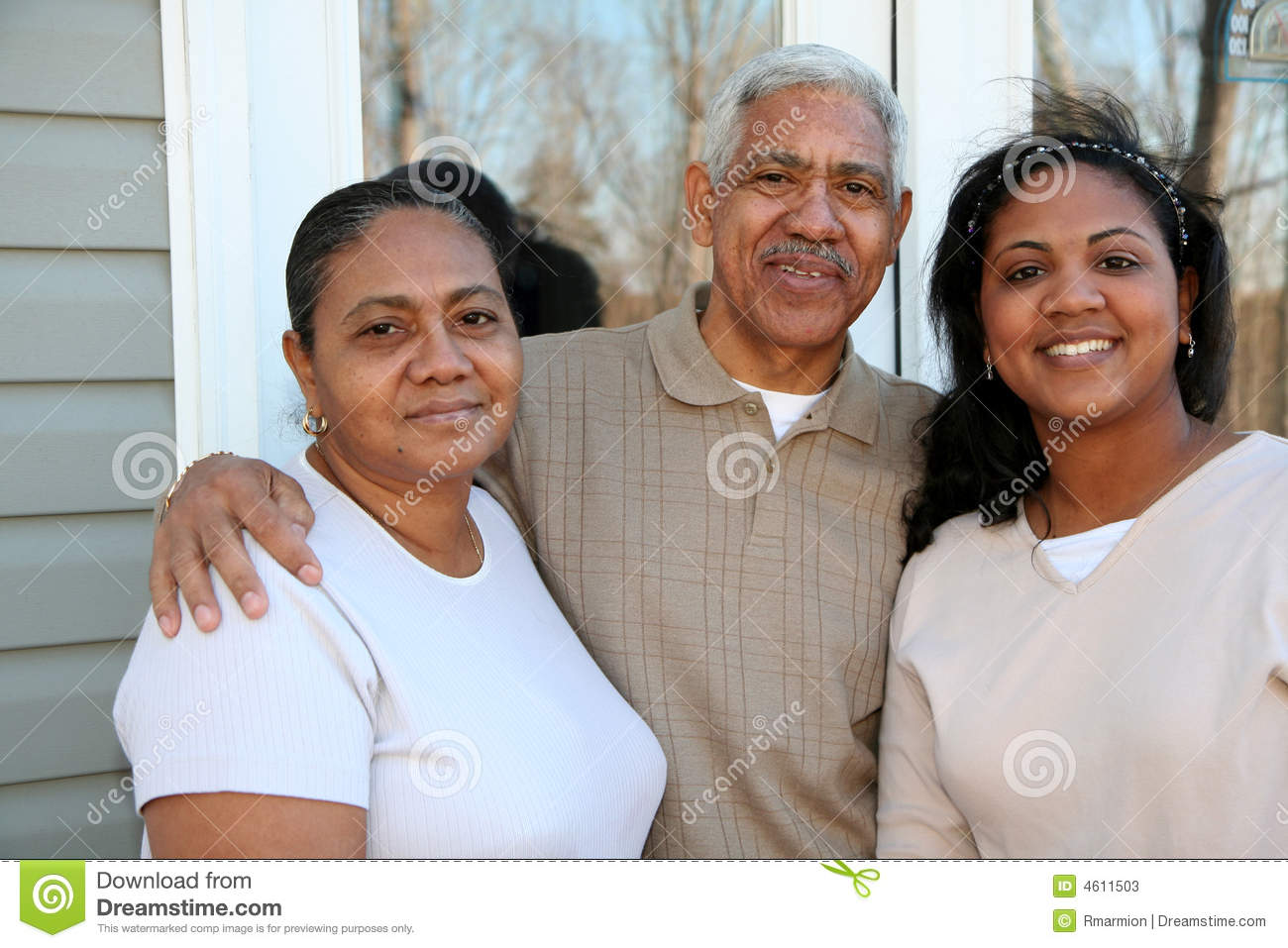 Minority Family Standing Outside Their New Home