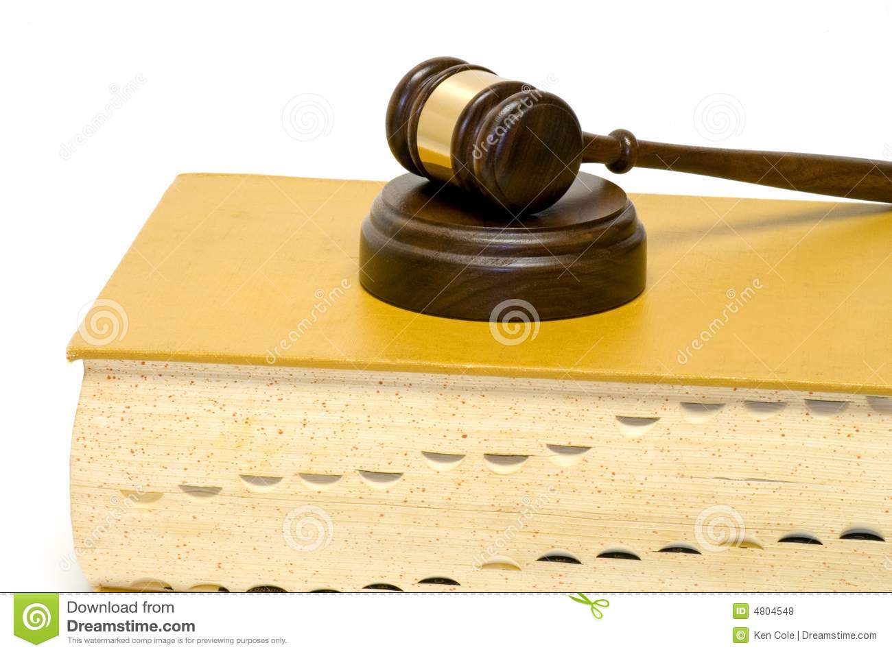 Wooden Gavel And Sounding Block Resting On A Large Indexed Law Book    