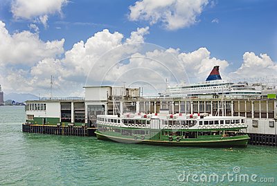 Star Ferry Waiting To Depart In A Terminal In Hong Kong With A Cruise