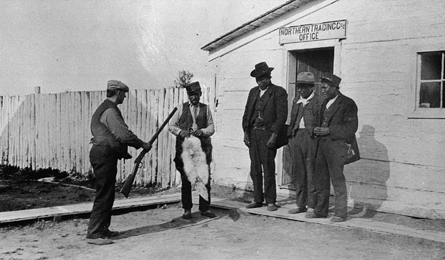 Trading Fur For A Gun    An Obviously Staged Photo From The 1920s
