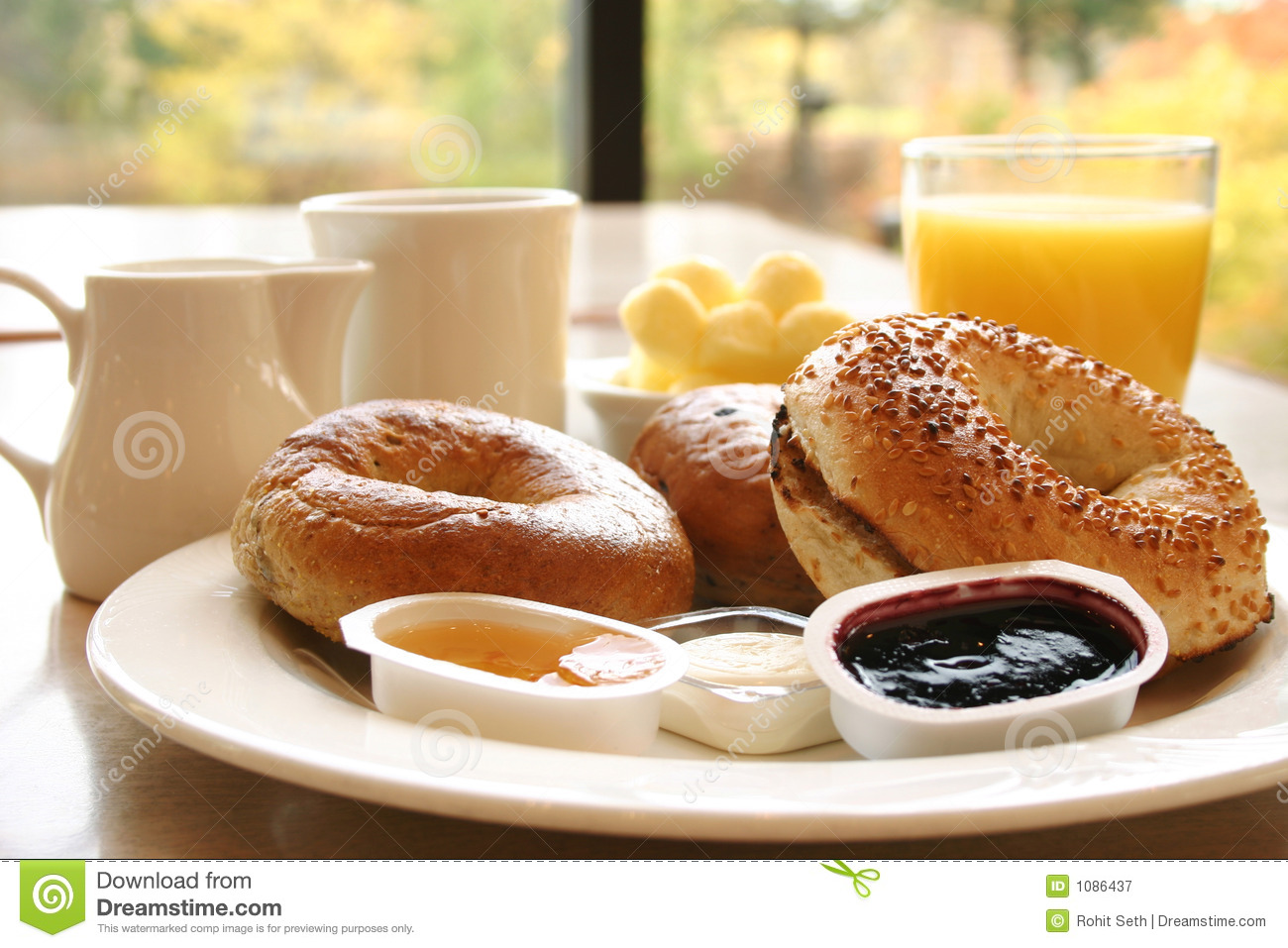Breakfast Of Coffee Toasted Bagels With Butter And Orange Juice
