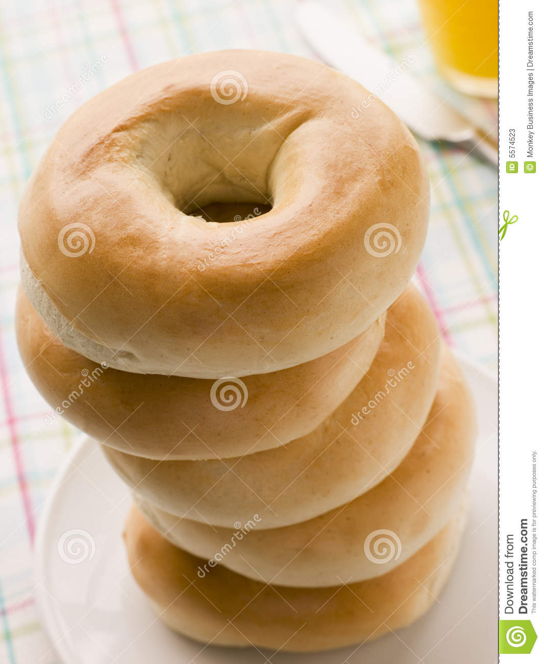 Stock Images Of   Stack Of Plain Bagels With A Glass Of Orange Juice