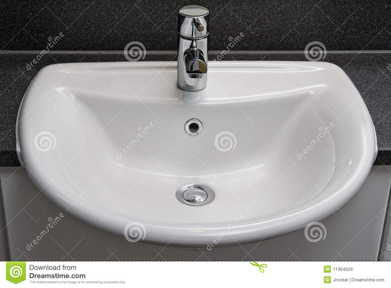 Detail Of A White Ceramic Bathroom Hand Wash Basin 