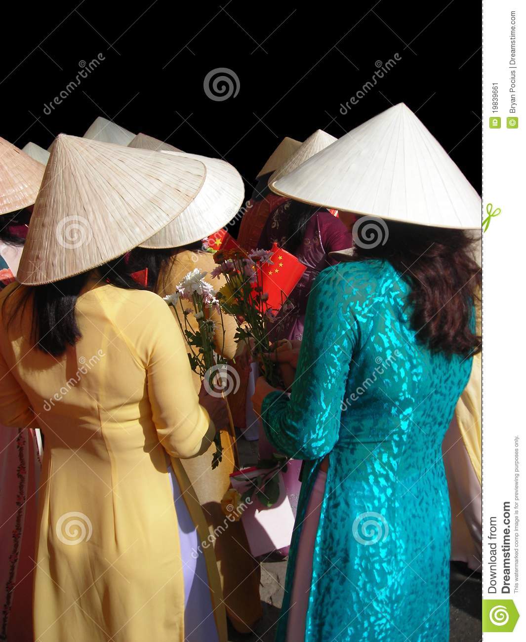 Vietnamese Women In Traditional Dress Attending A Ceremony