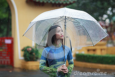 Vietnamese Women Wear Ao Dai Holding Umbrella In The Rain