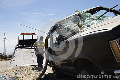 Man Preparing To Lift Crashed Car Onto Tow Truck Royalty Free Stock