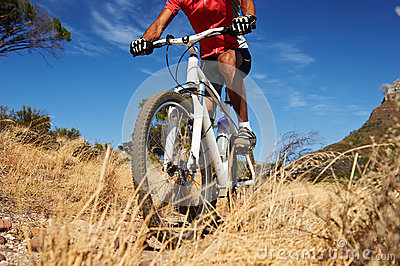 Mountain Bike Man With Blue Sky Riding On Outdoor Trail In Nature 