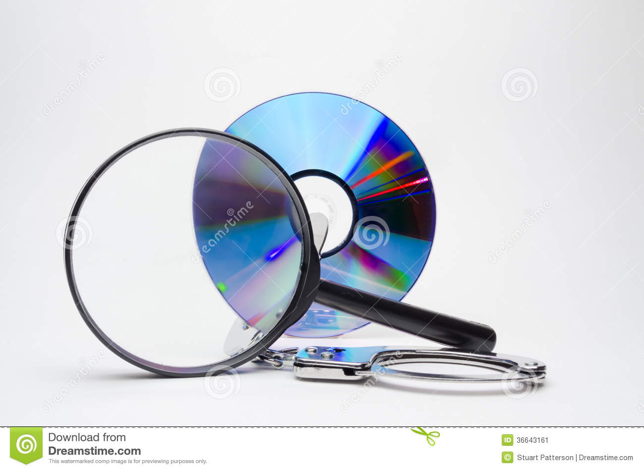 Magnifying Glass With Dvd And Handcuffs  Showing The Analysis Of
