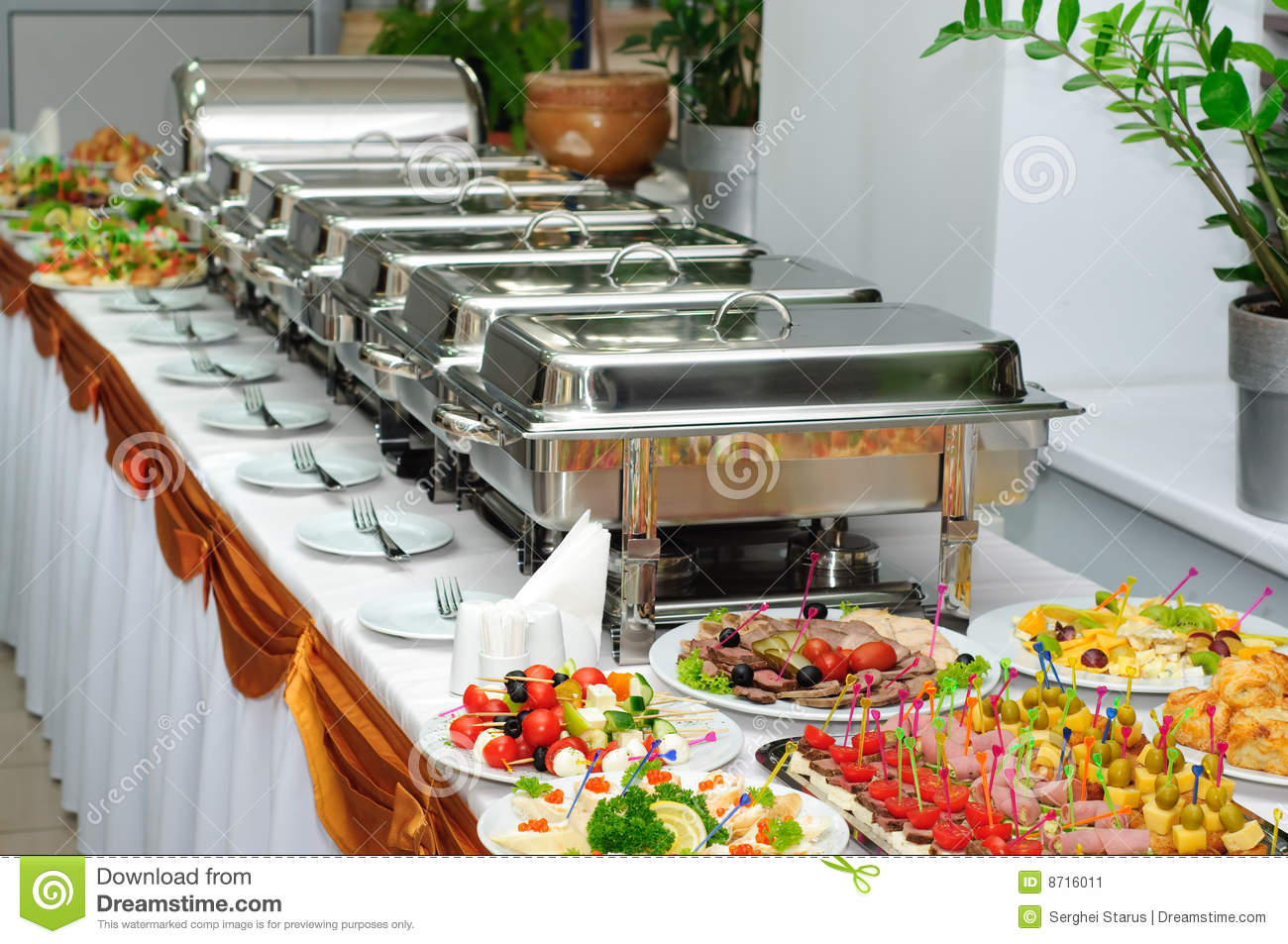 Banquet Table With Chafing Dish Heaters And Canapes