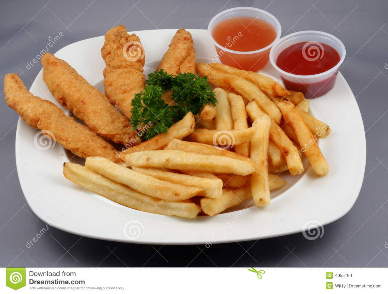 Chicken Fingers And French Fries With Ketchup And A Dipping Sauce