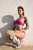 Stock Photo Of Sexy Tattooed Woman In Pink Bikini Holding Fuzzy Dice