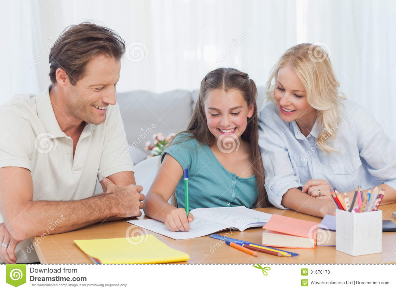 Parents Helping Her Daughter Doing Her Homework At Desk In Living Room    