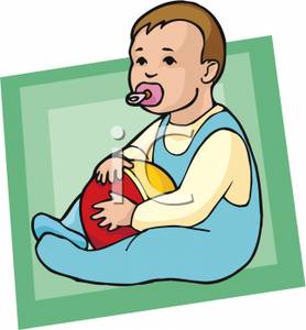 Toddler Boy Sitting Down Holding A Ball And Sucking On A Pacifier