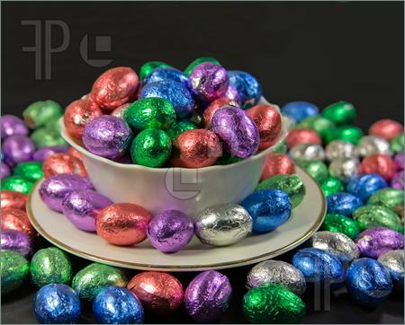 Photograph Of Overflowing Bowl And Plate Of Easter Eggs On Black