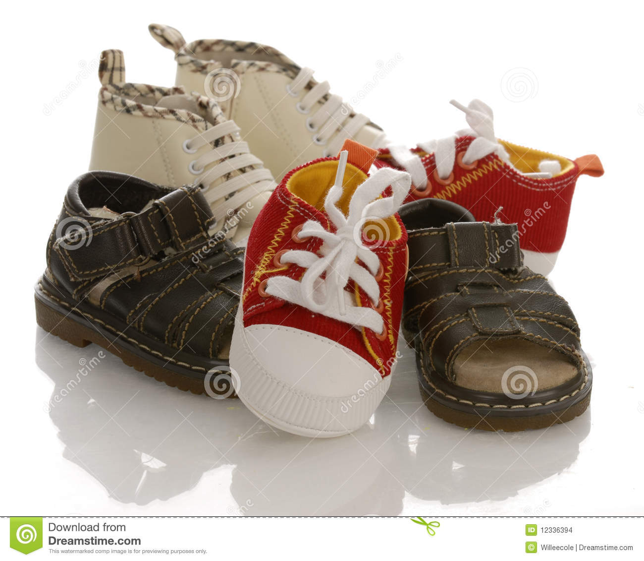 Pile Of Baby Or Infant Shoes With Reflection On White Background