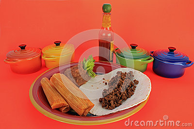 Hot Tomales Still In Cornhusk On Colorful Mexican Plate With Refried    