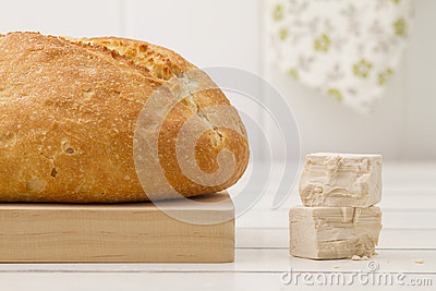 Bread A Tablecloth And Baker S Yeast In A White Wooden Table