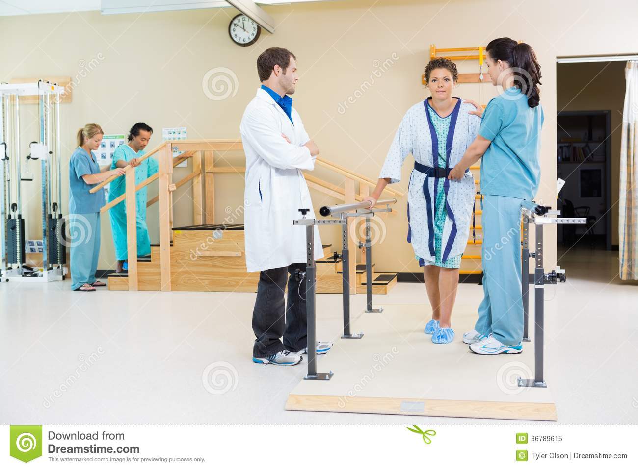 Royalty Free Stock Photo  Physical Therapists Assisting Female Patient