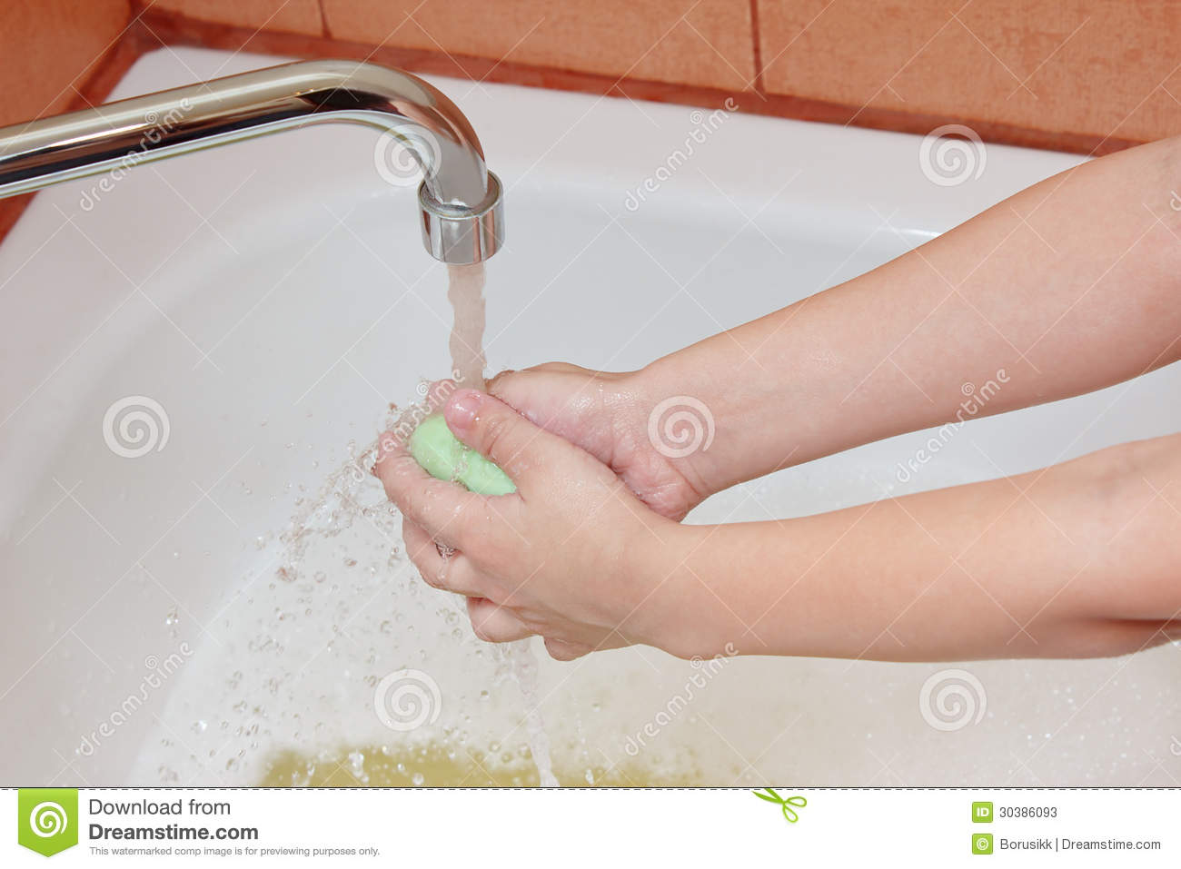 Washing Childrens Hands Under The Faucet In Bathro Stock Photos