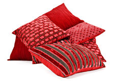 Red Cushions Stacked Up On A White Background Stock Images