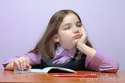 Tired Little School Girl Doing Homeworks At Desk Royalty Free Stock