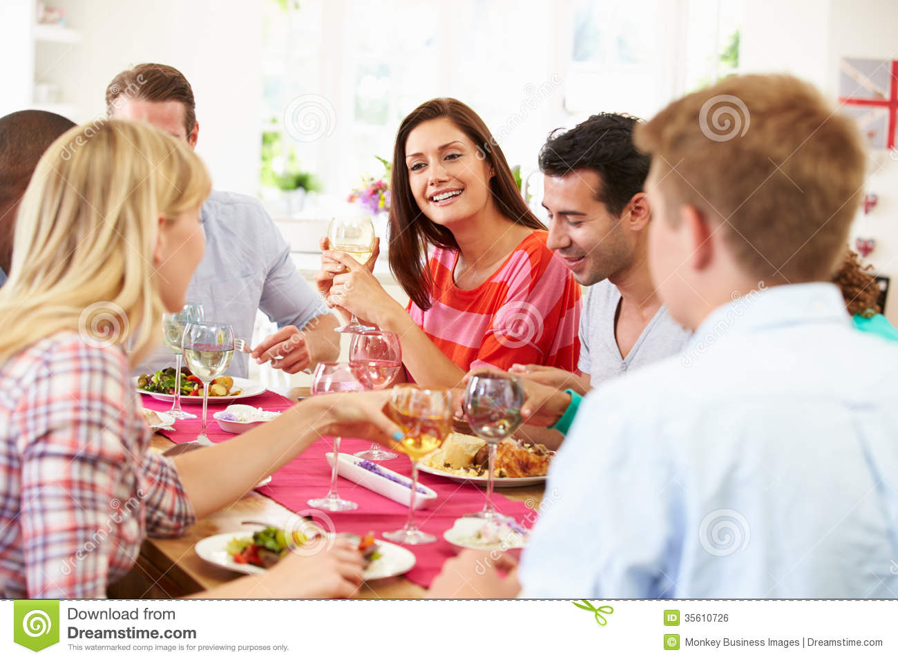 Group Of Friends Sitting Around Table Having Dinner Party Royalty Free    