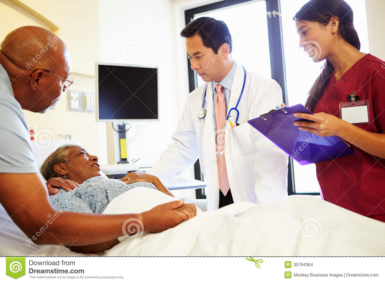 Medical Team Meeting With Senior Couple In Hospital Room Stock Images    