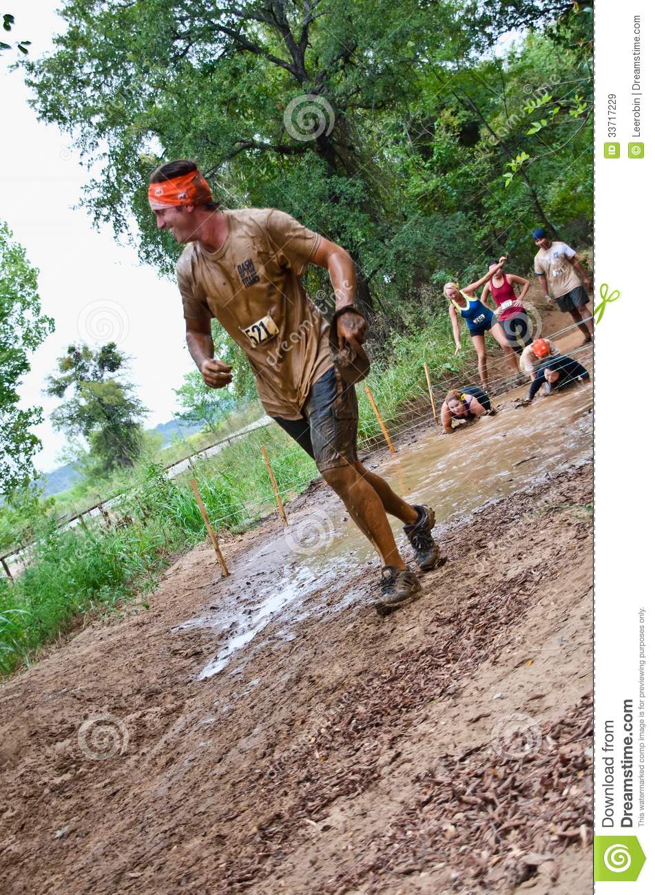 Mud Run Race Participant Passing Through A Mud Pit  Dash Of The Titans