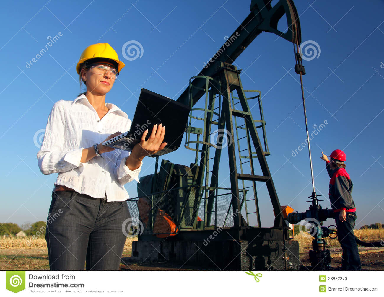 Female Engineer And Oil Men Working Together In An Oilfield Teamwork 
