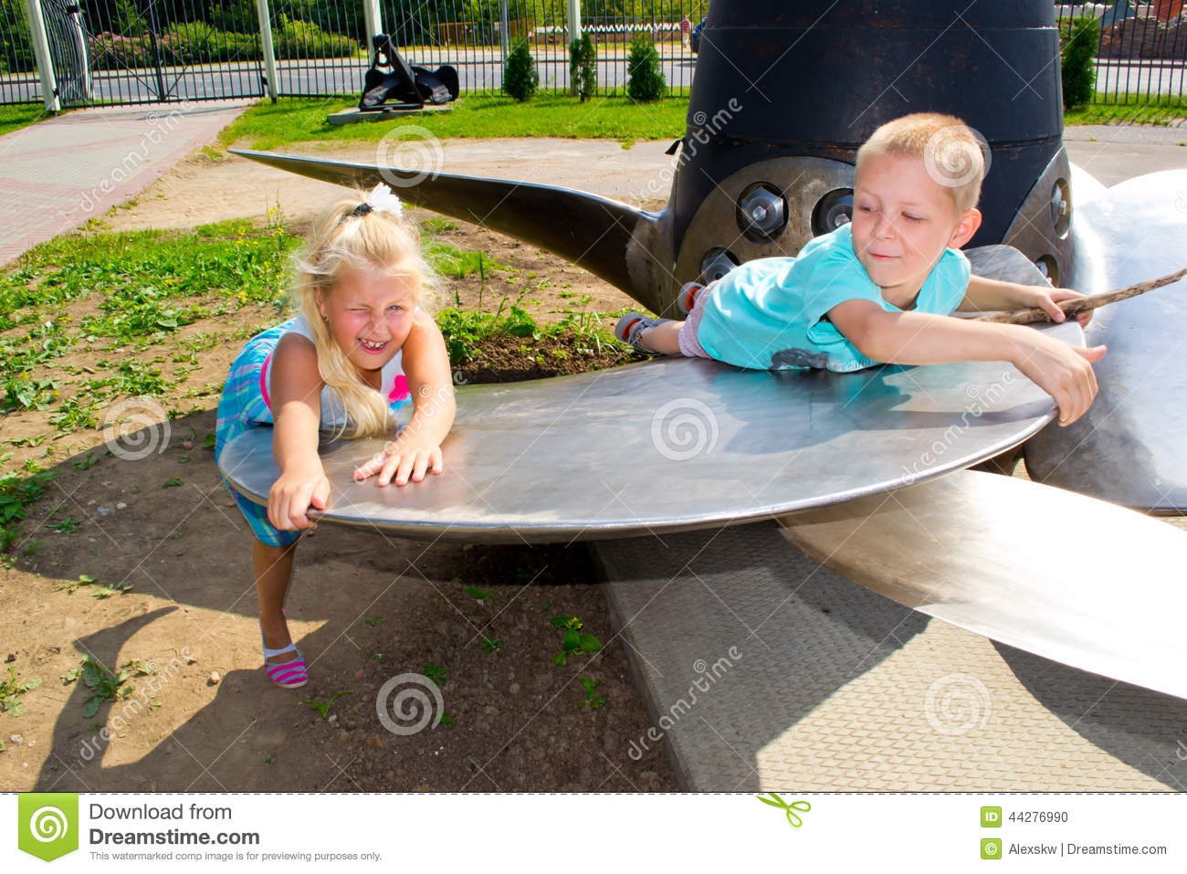 Children Playing On The Huge Metal Ship S Propeller