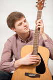 Portrait Of Young Handsome Man Playing On Acoustic Guitar Stock Images