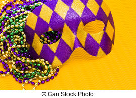 Mardi Gras Beads And Mask On Yellow Backgound