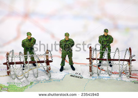 Miniature Border Patrol Guards Stand On A Map At The Usa Mexico Border