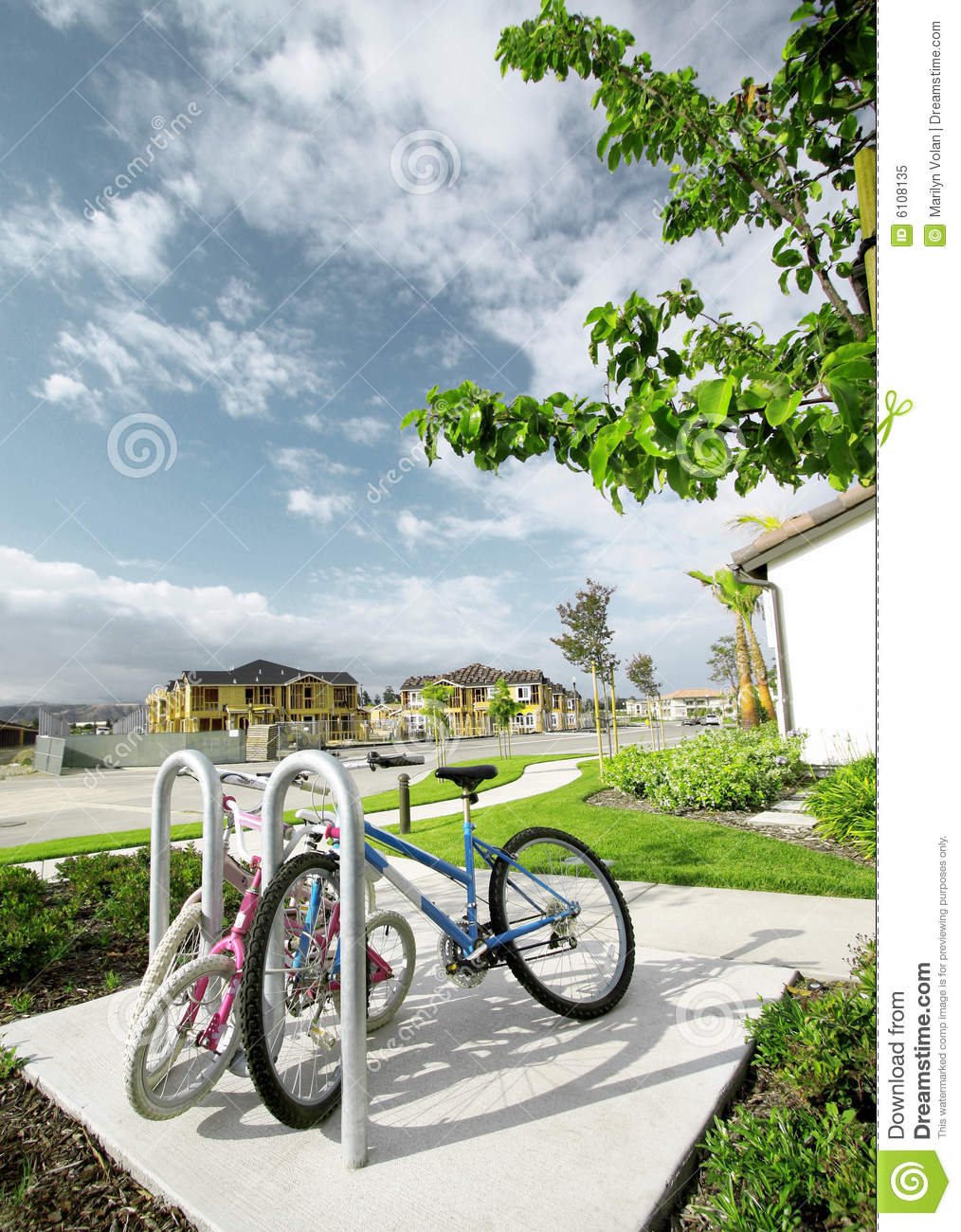Parked Bicycles On The Sidewalk In A Modern Neighborhood Housing    