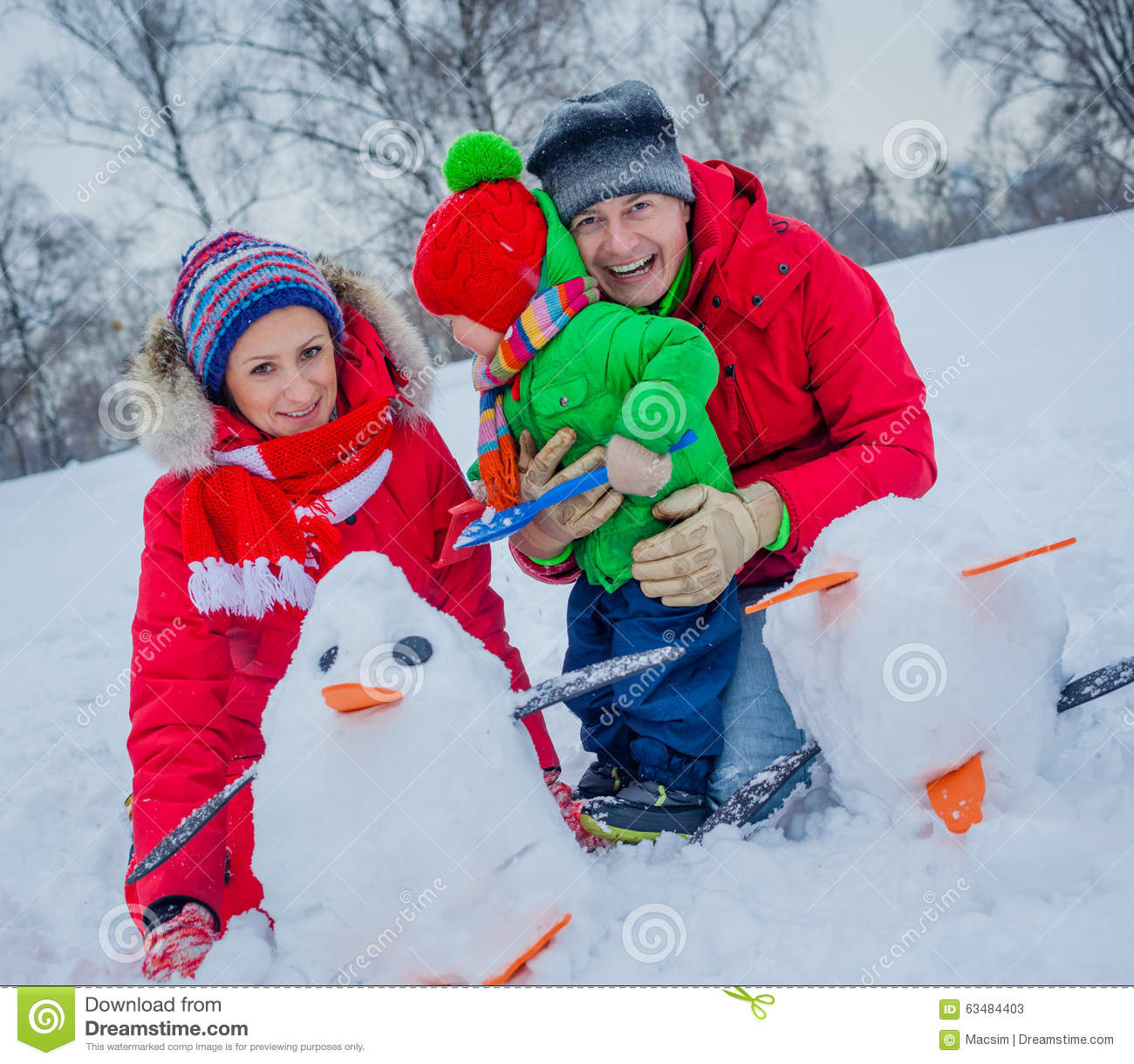 Cheerful Family Of Three Playing Snow In The Winter Forest 