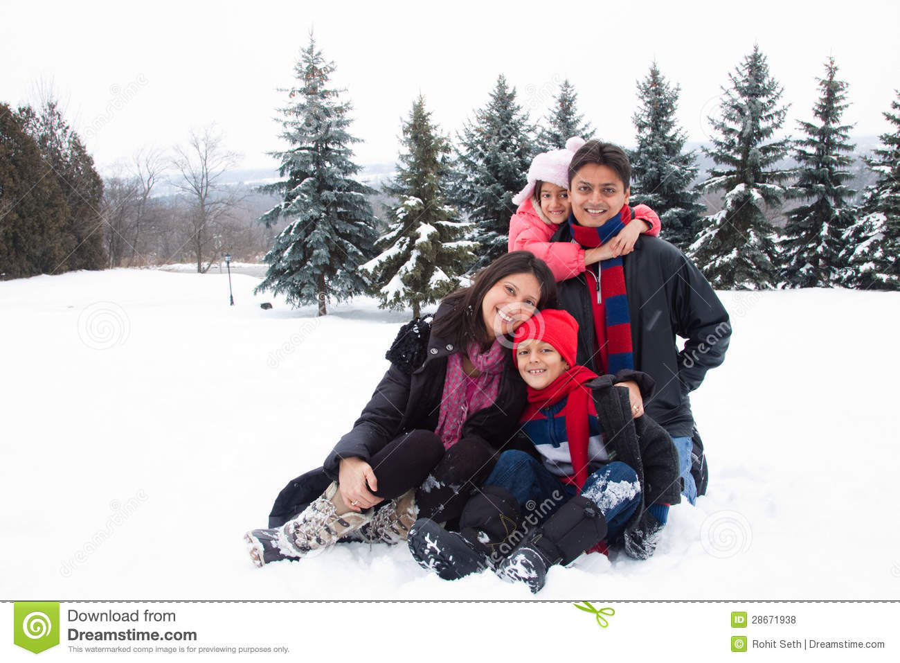 East Indian Family Playing In The Snow Royalty Free Stock Photos