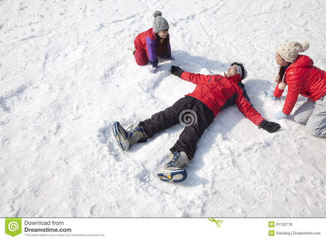 Stock Photos  Family Playing In The Snow Father Making Snow Angel