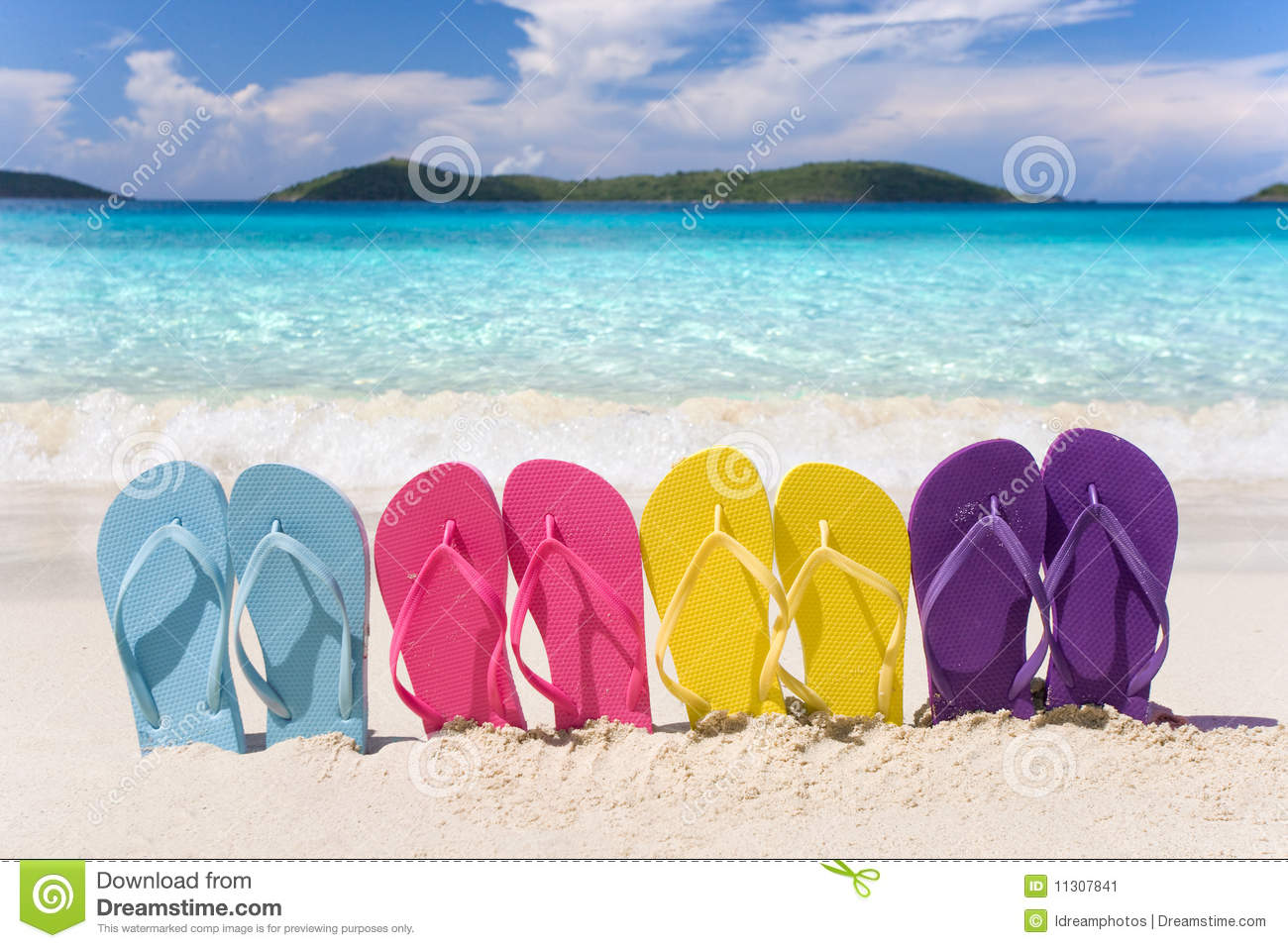 Rainbow Colored Flip Flops Lined Up In A Row On Tropical Beach